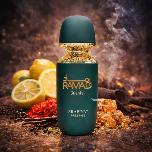 Teal bottle of RAMAD Arabiyat Prestige perfume with lemons and spices on a dark background