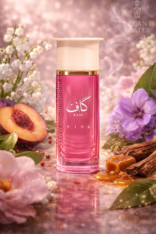 Pink perfume bottle labeled 'Kaaf' surrounded by flowers and fruit on a soft pink background.